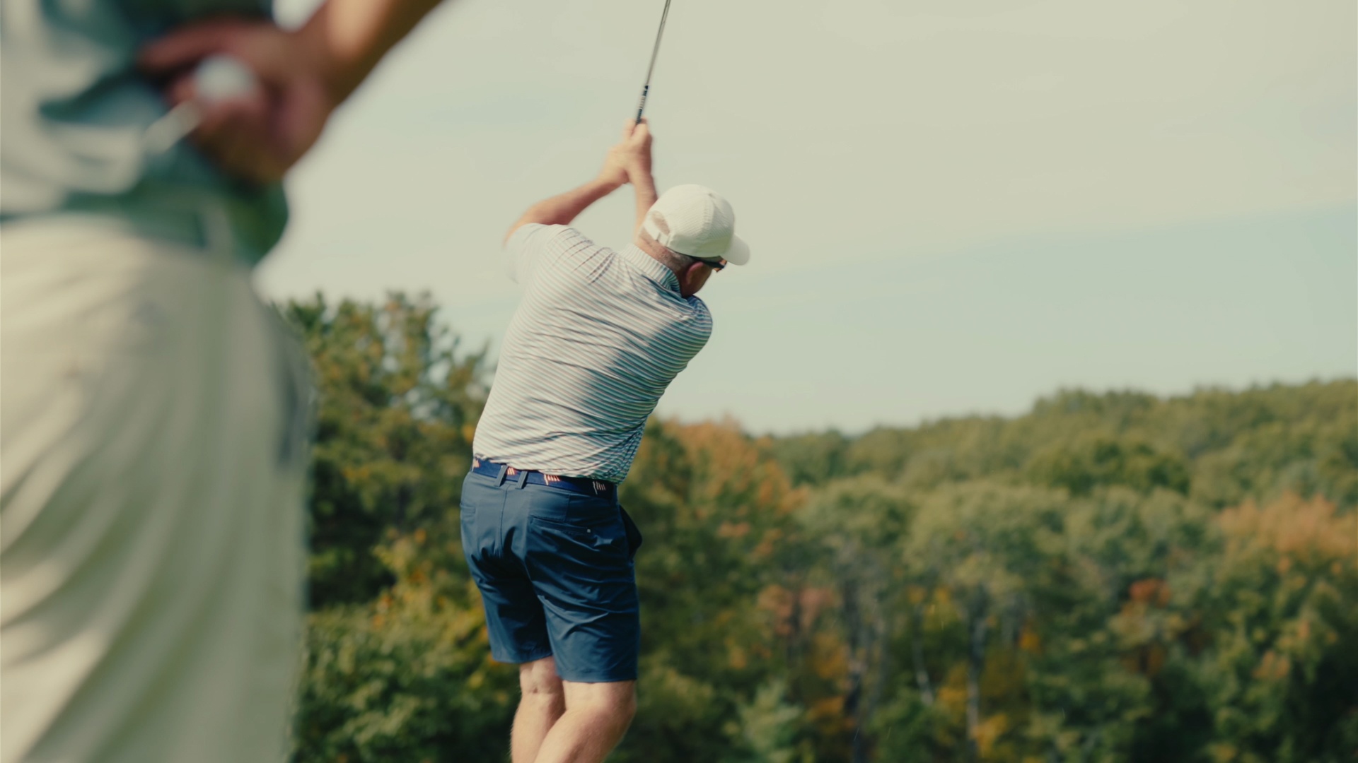 Follow-through over the fall tree line