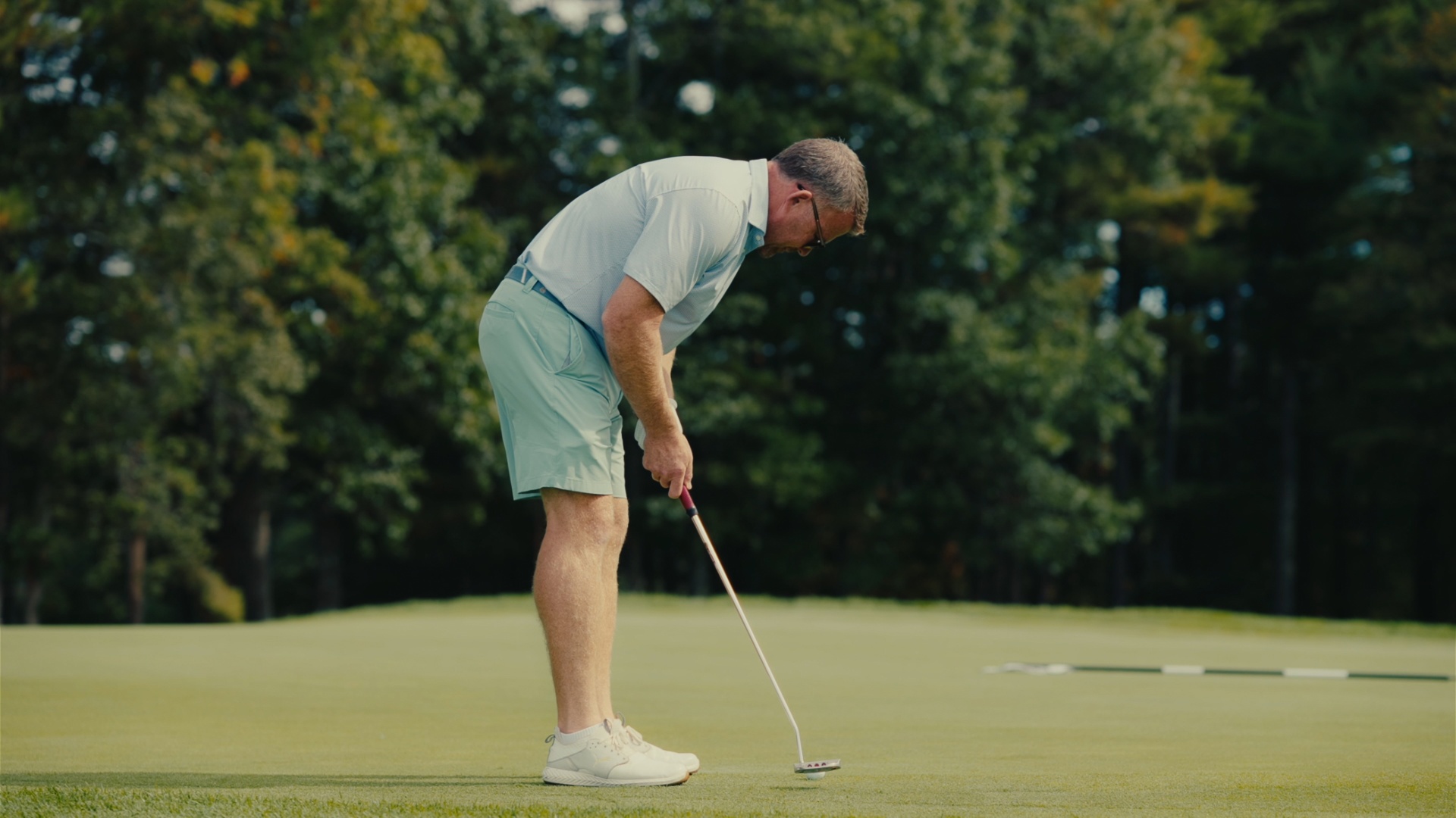 Player lining up a putt on the green