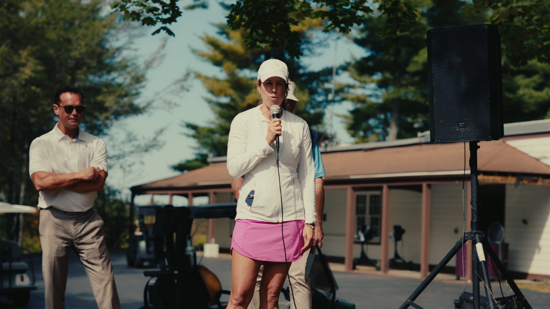 Tournament host speaking to guests outside the clubhouse