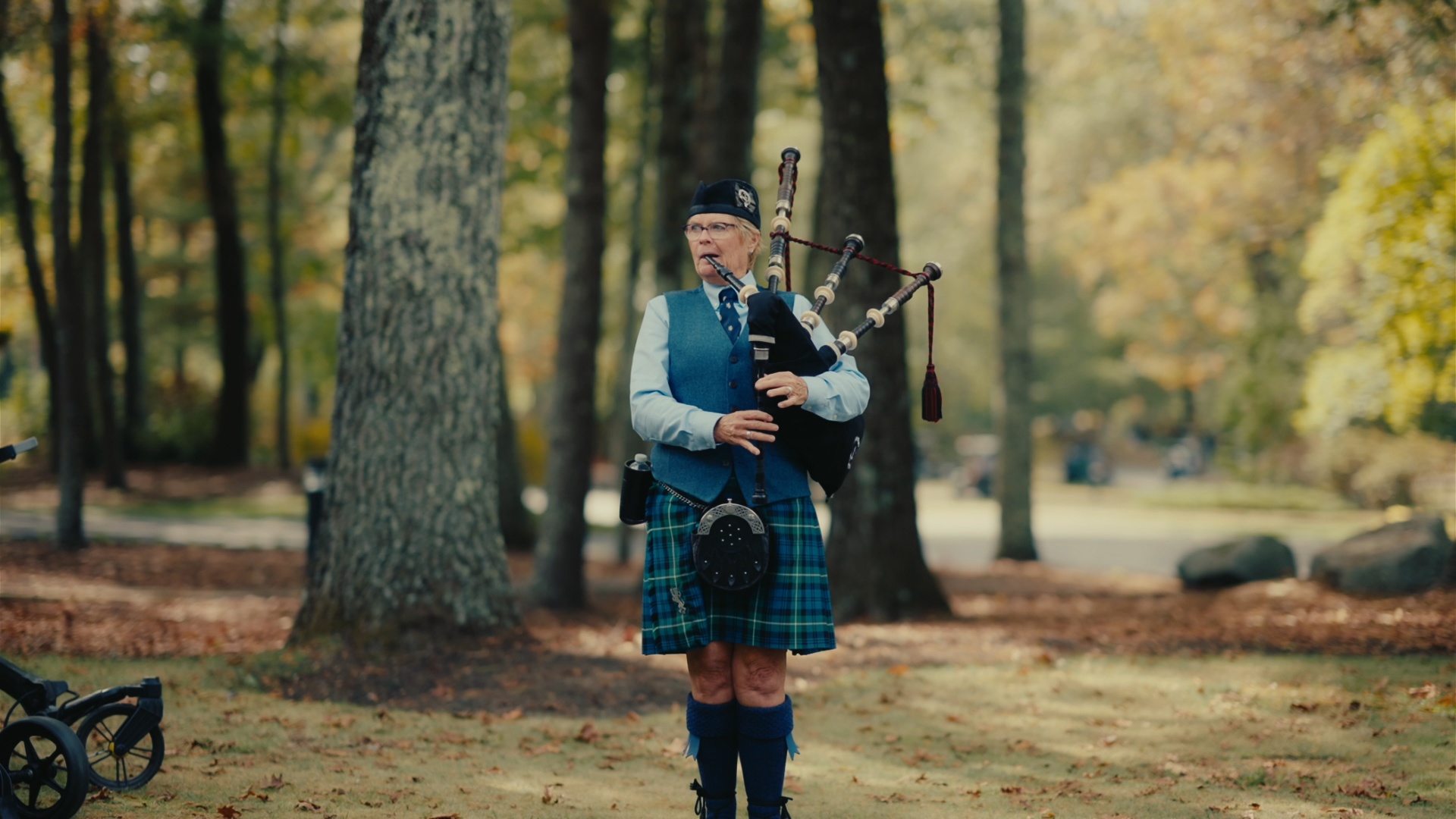 Bagpiper performing among the trees