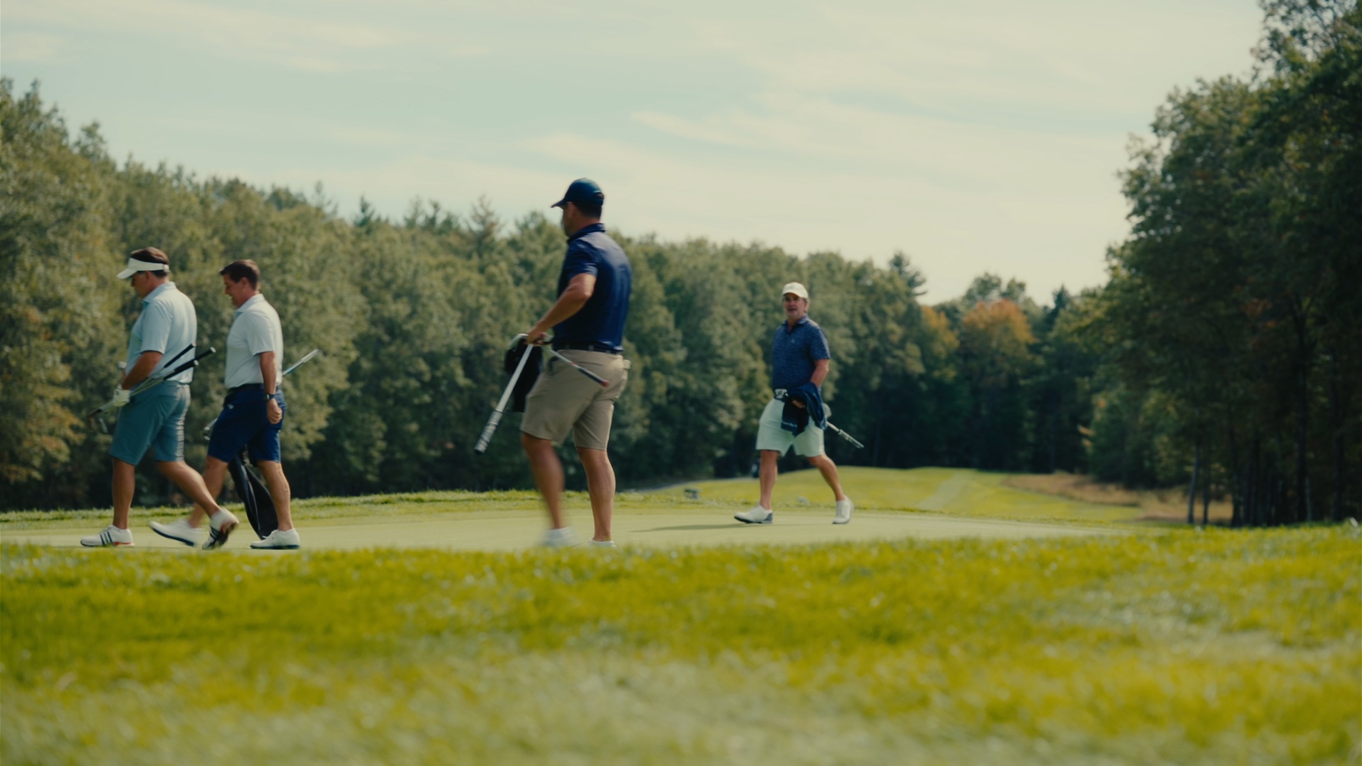 Foursome walking across the green