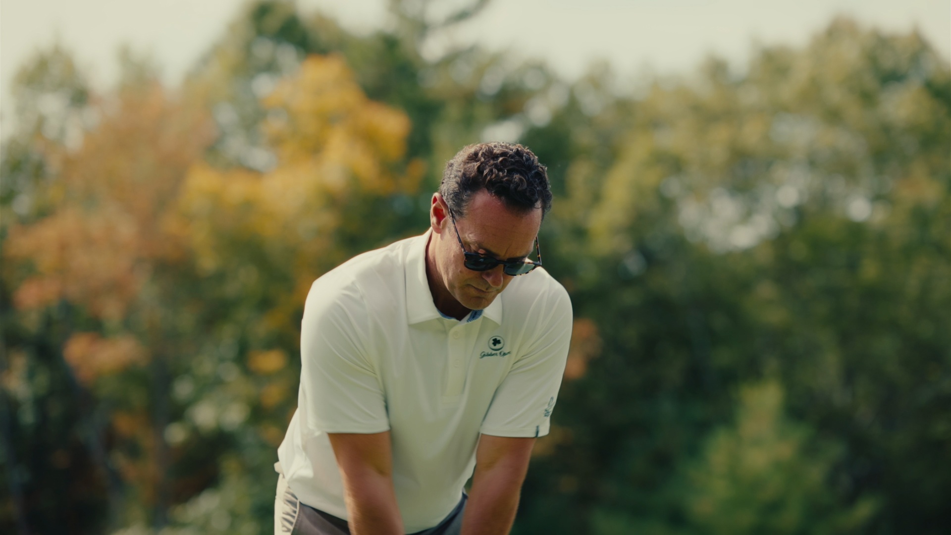 Player focused over the ball on the tee