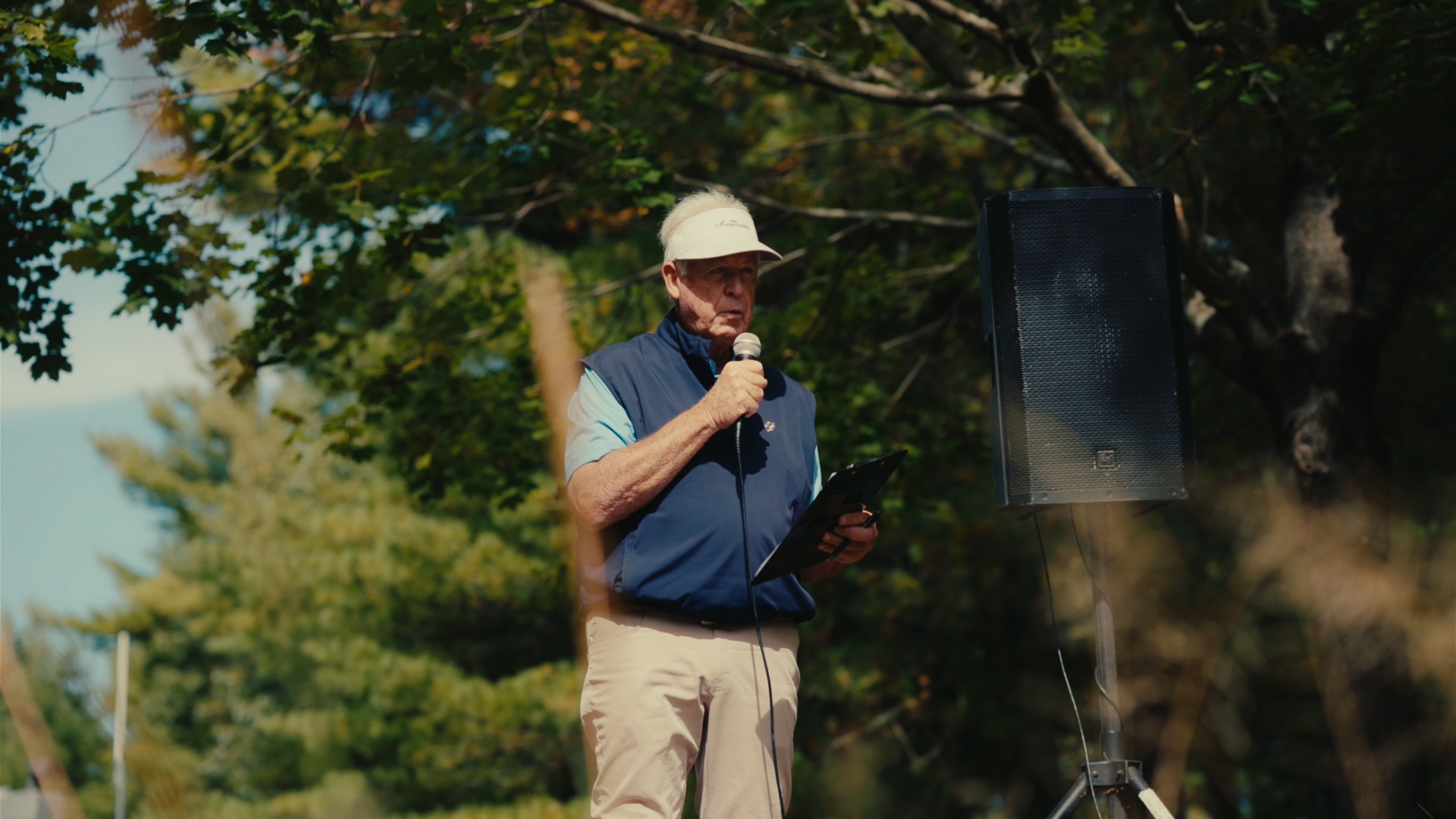 Organizer reading announcements to the field