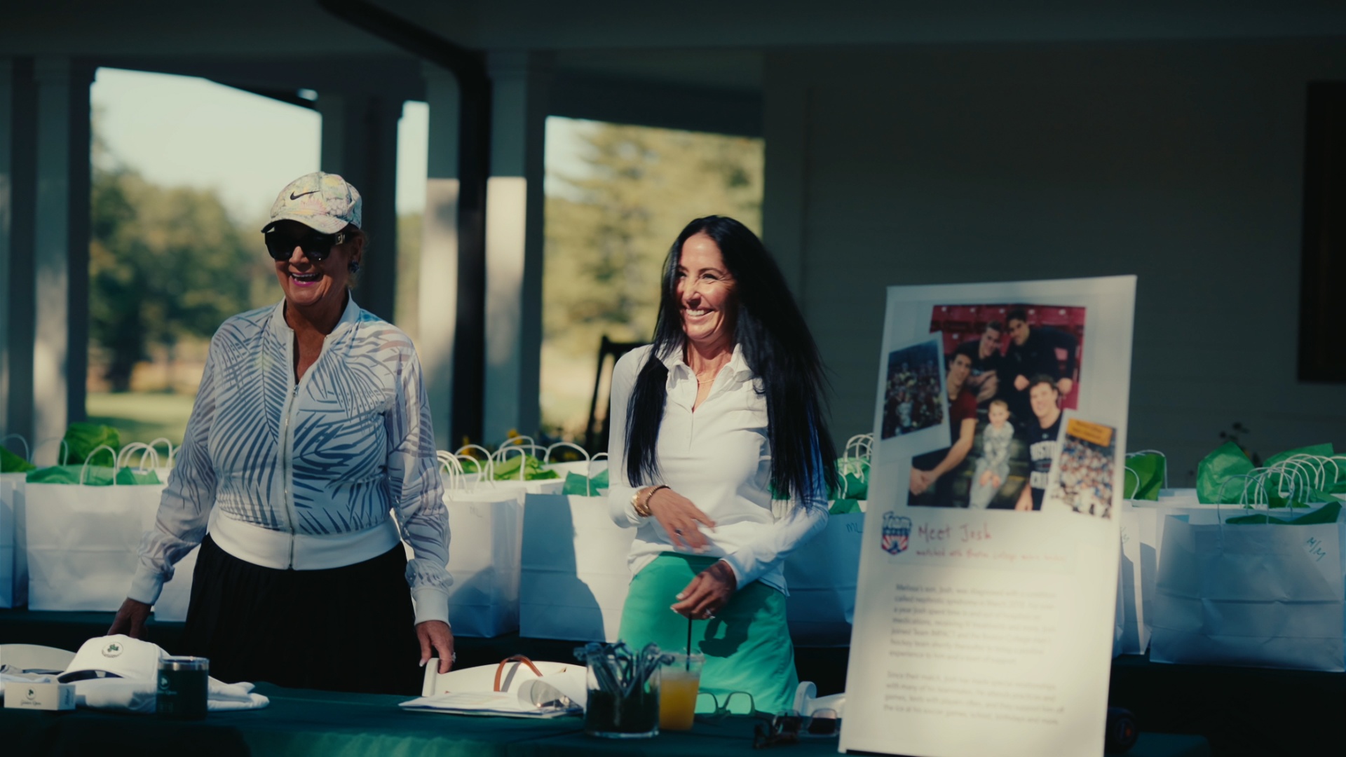 Volunteers greeting guests at the Team Impact welcome table