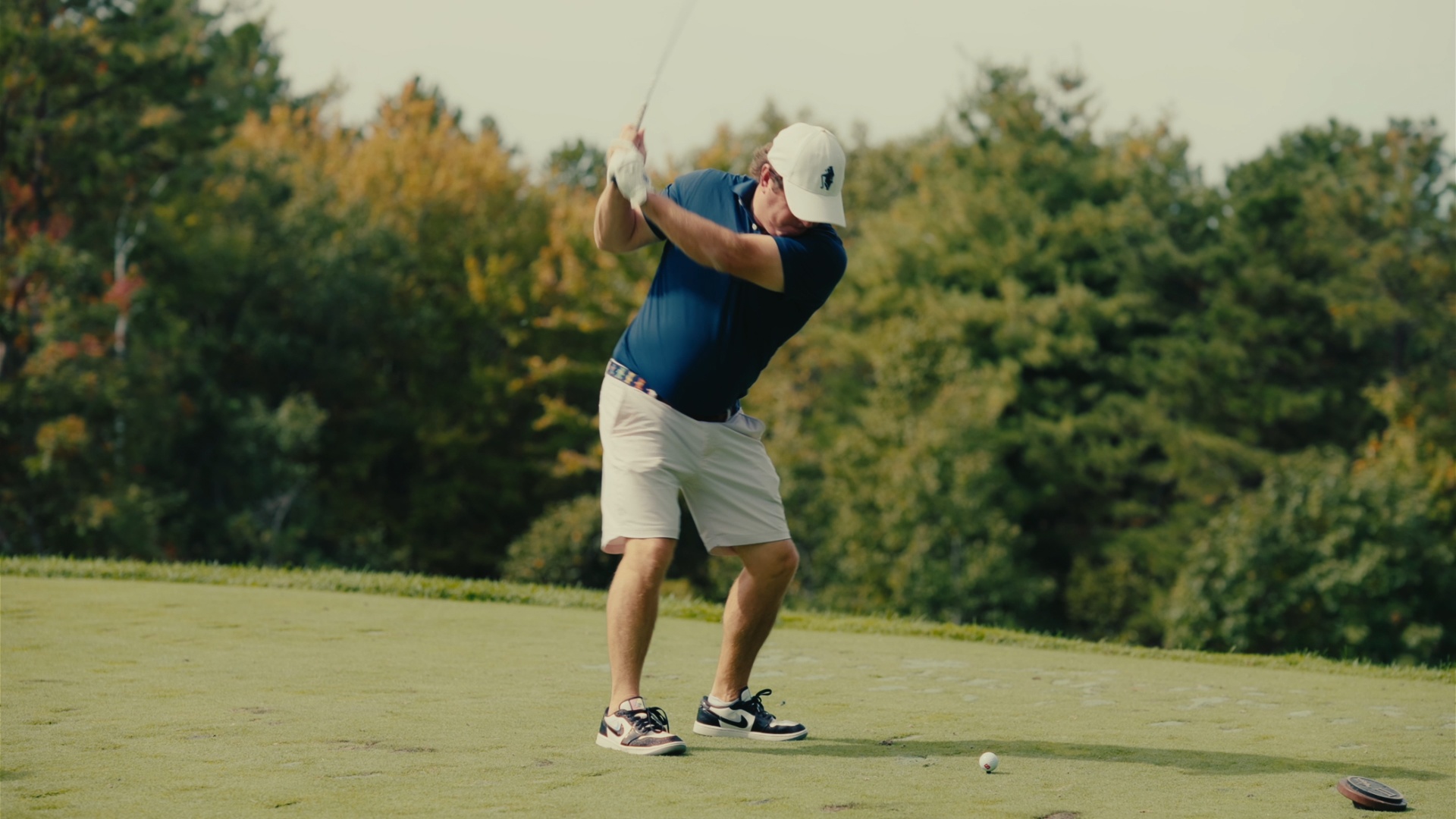 Player at the top of his backswing on the tee box