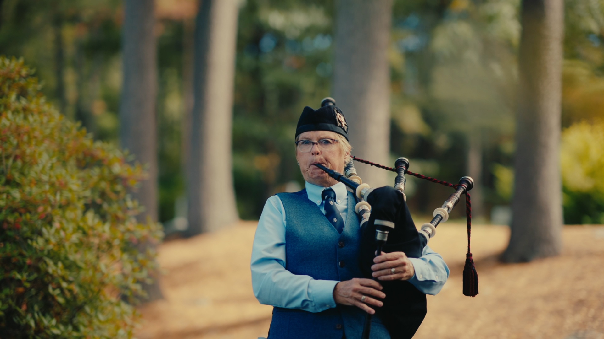 Bagpiper performing on course